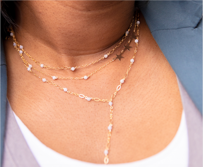 beaded necklace stacked with two other necklaces on girl
