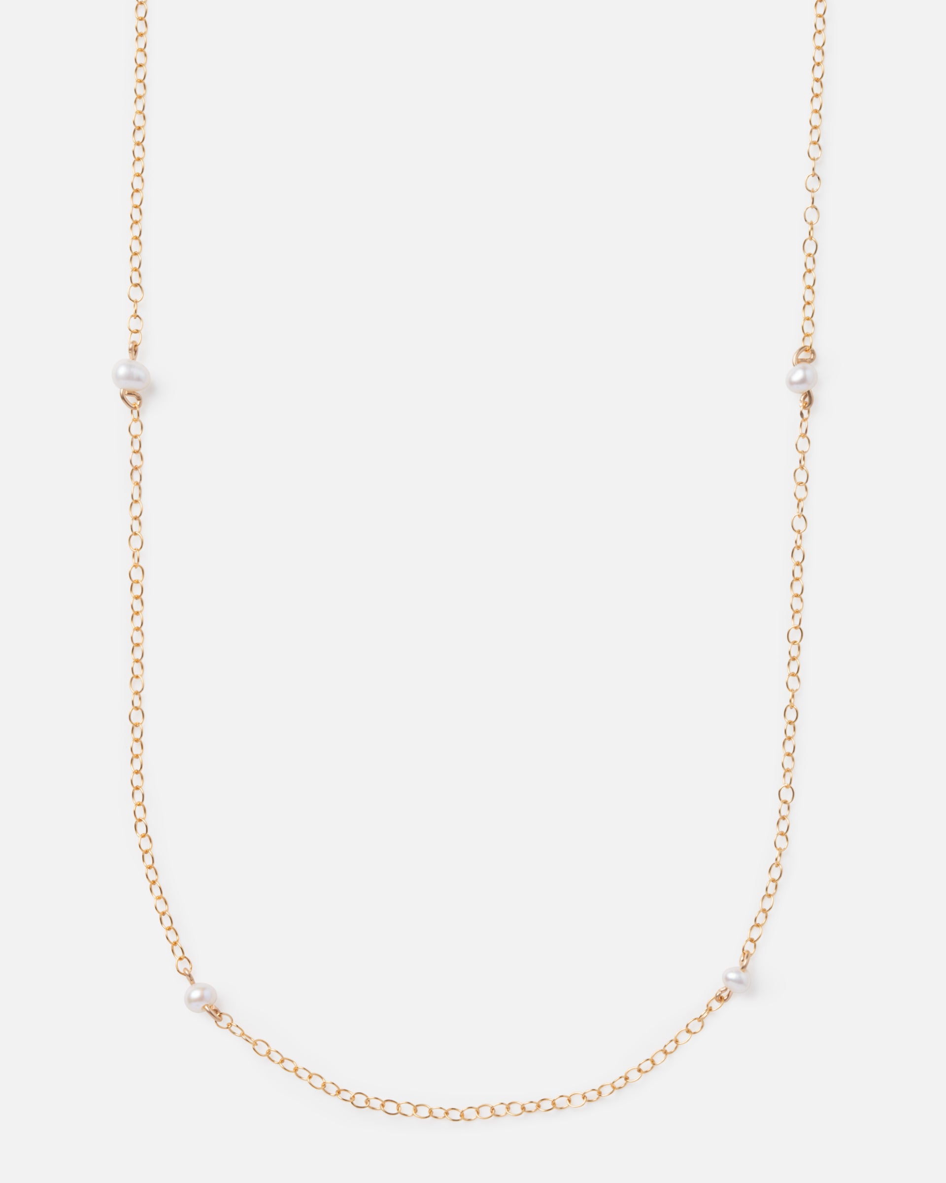 pearl beads on a long gold chain